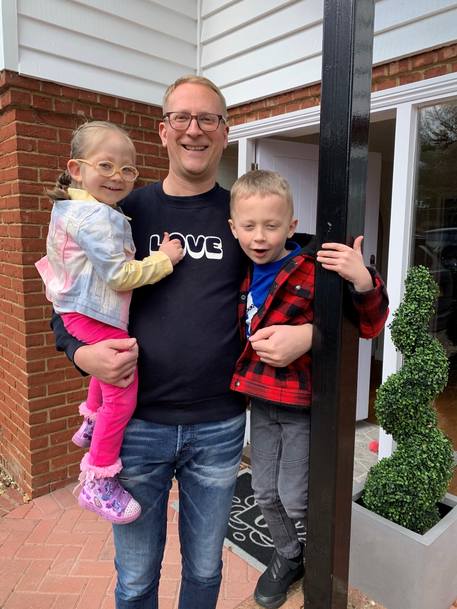 Demelza Lottery winner, Russell, with his two children.